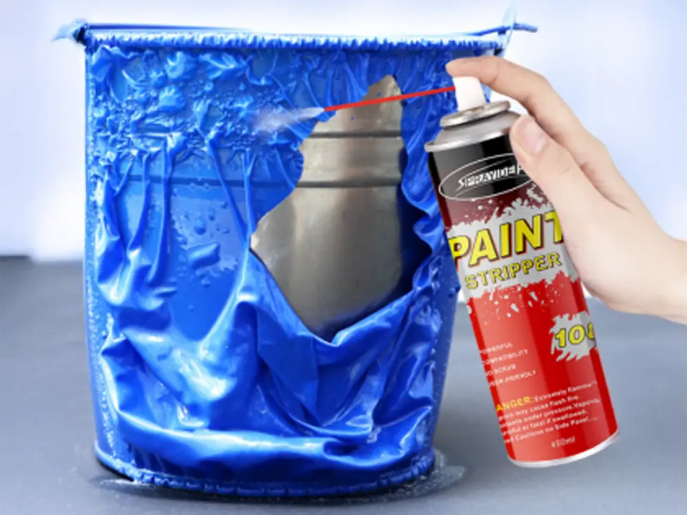 Image showing Sprayidea 108 Paint Stripper being sprayed onto a blue coating on a bucket, demonstrating its powerful and effective paint removal process on a metal surface.